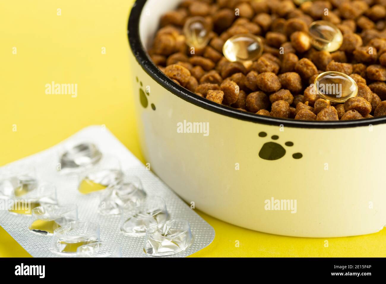 Animal food with tablets in a bowl. Vitamins for animals. Treating cats