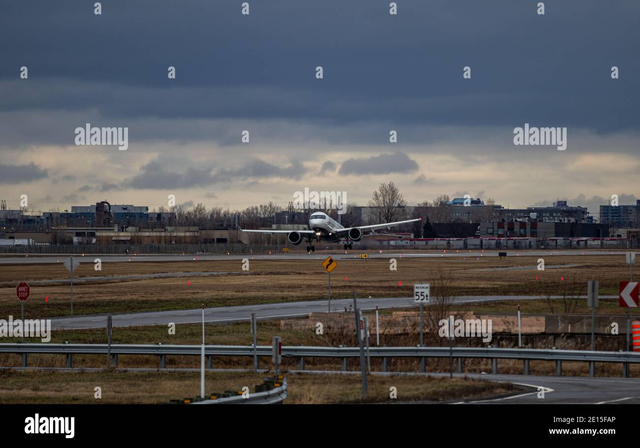 Montreal, Quebec, Canada - 12-13-2020 : Air Canada Airbus A220 landing in crosswind conditions at Montreal's Intl. airport. Stock Photo
