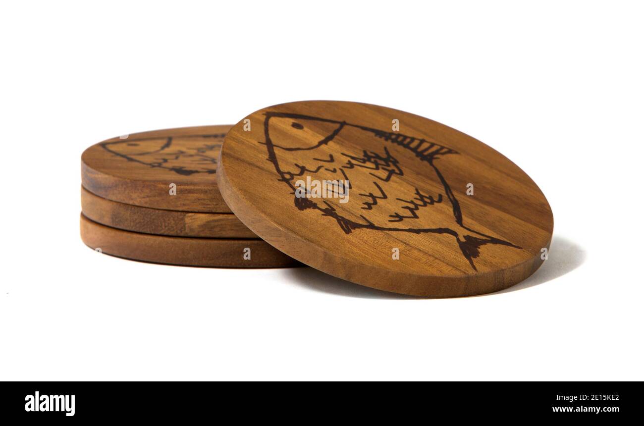 Wooden fish coaster set from ED by Ellen fashion line by Ellen Degeneres photographed on a white background Stock Photo