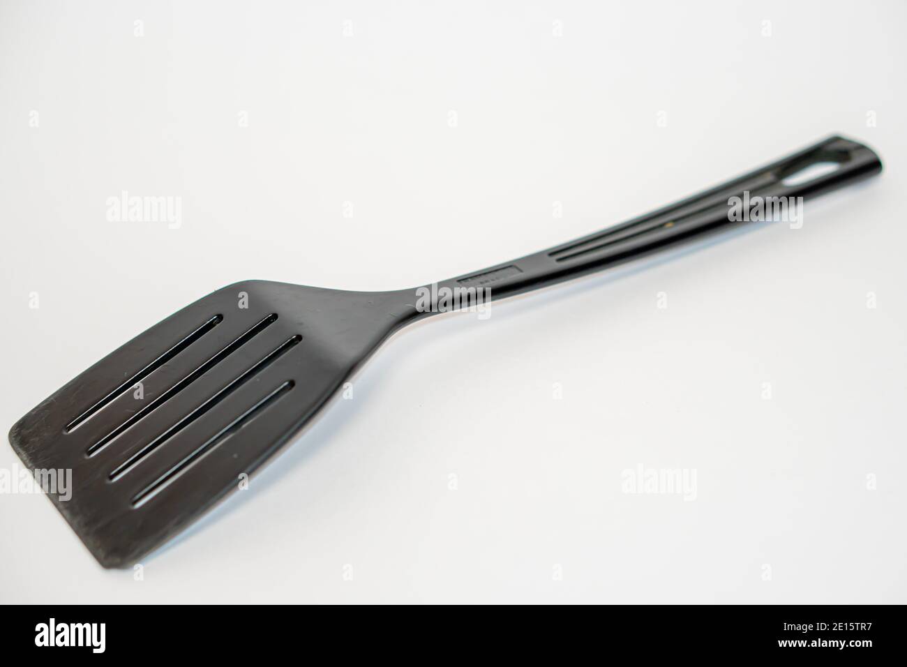 Black plastic kitchen spatula isolated on white background Stock Photo