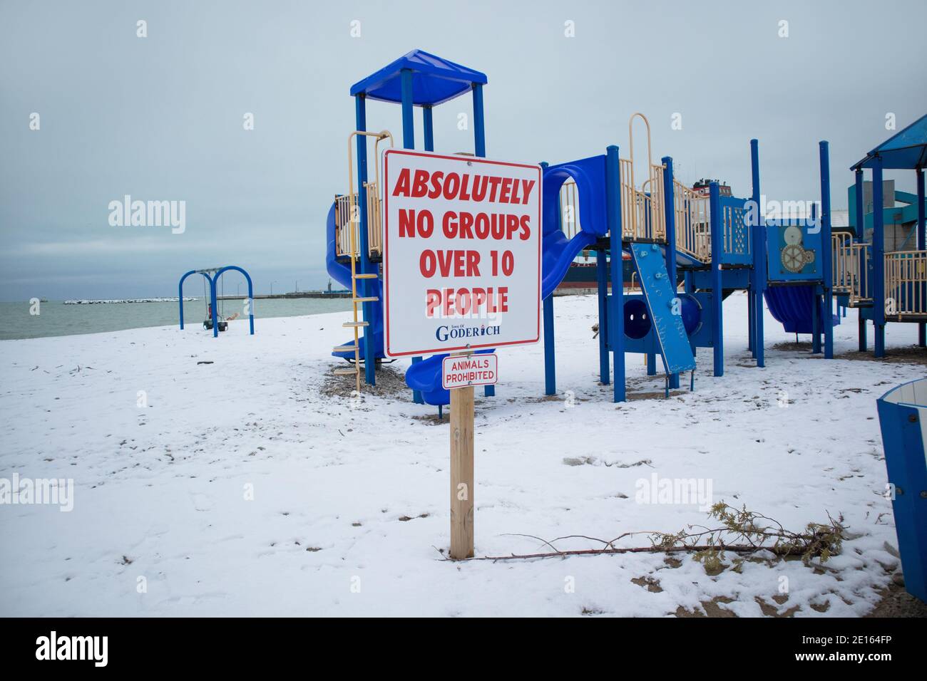 On the beach, close to the playground, the signage says: Absolutely no groups over 10 people.. Stock Photo