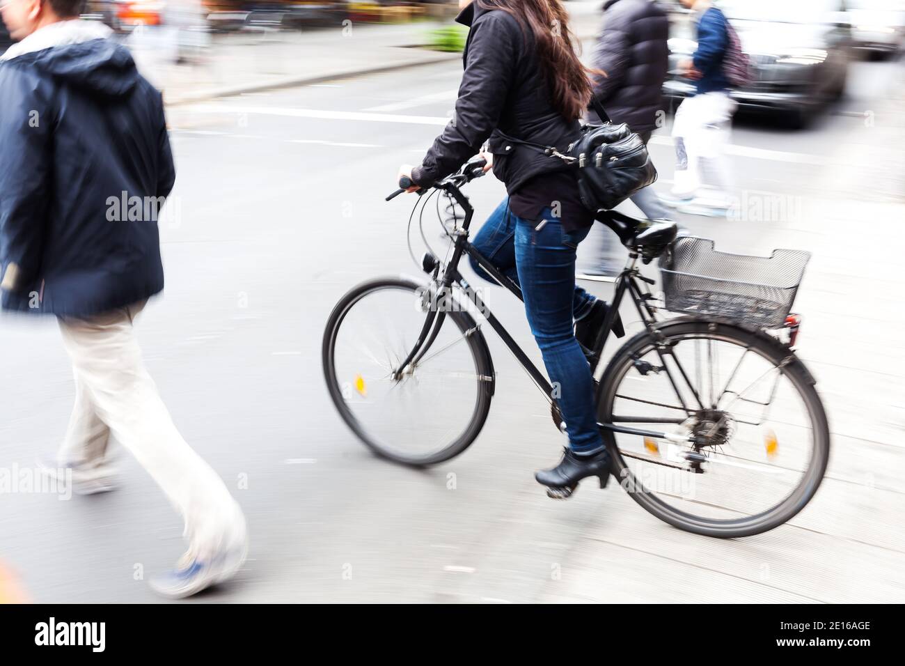 picture with camera made motion blur effect of a bicycle rider crossing ...