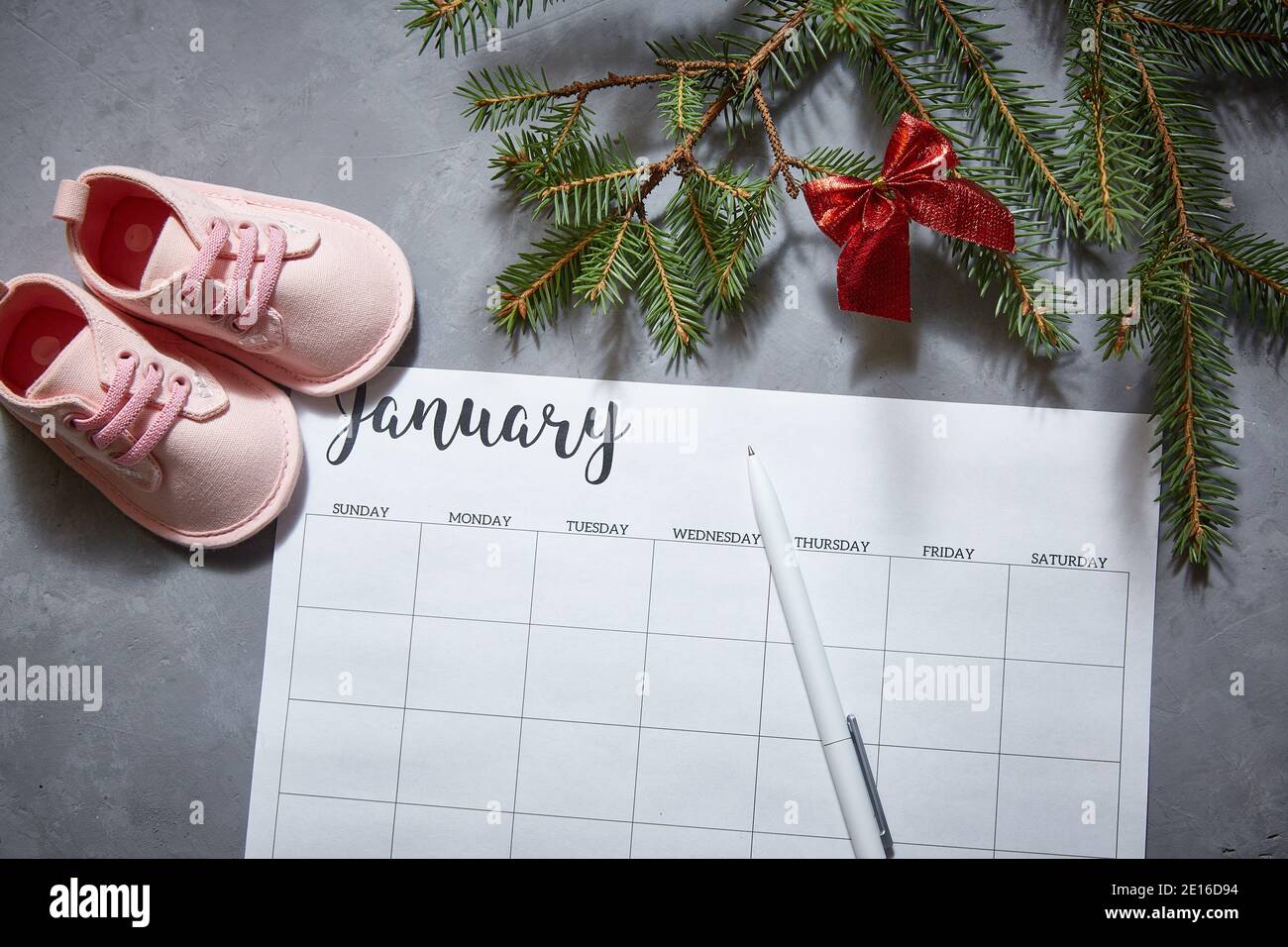 Baby's shoes, winter calendar for January. The announcement of the pregnancy Stock Photo