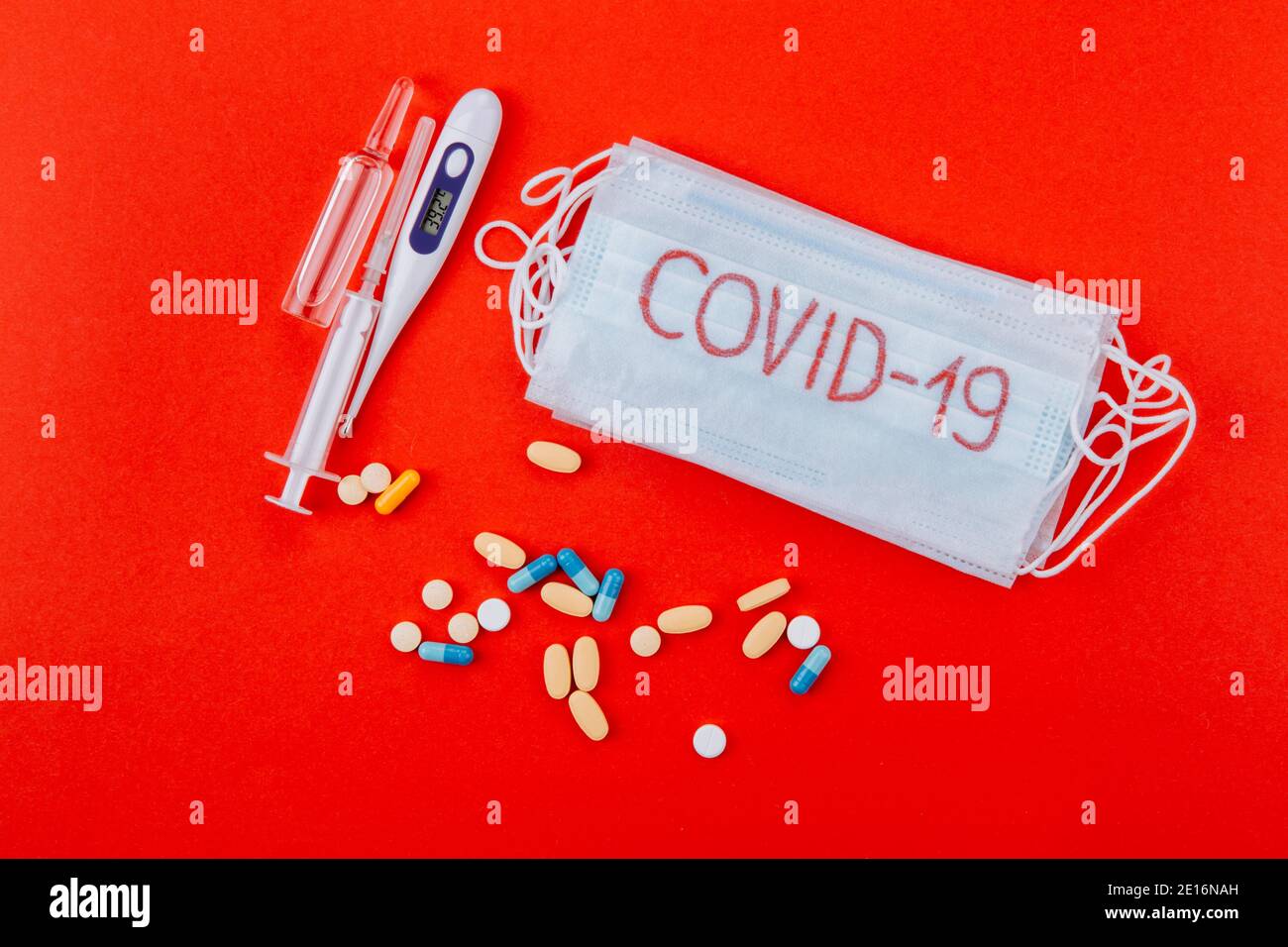 Protective medical mask with the inscription Covid-19, syringes ...
