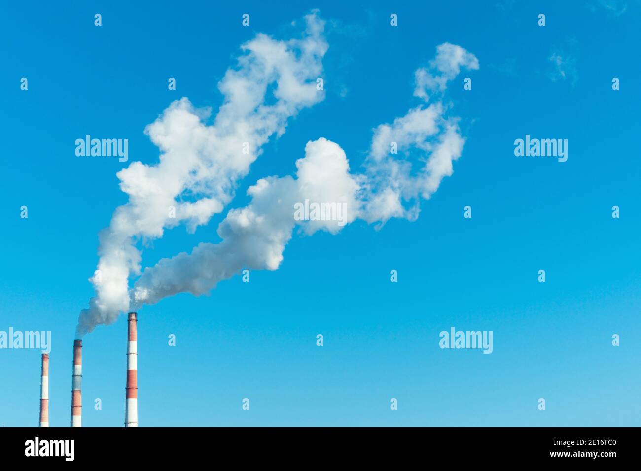 Smoking chimneys of the power plant. The use of natural gas as a fuel reduces the damage to the environment. Stock Photo