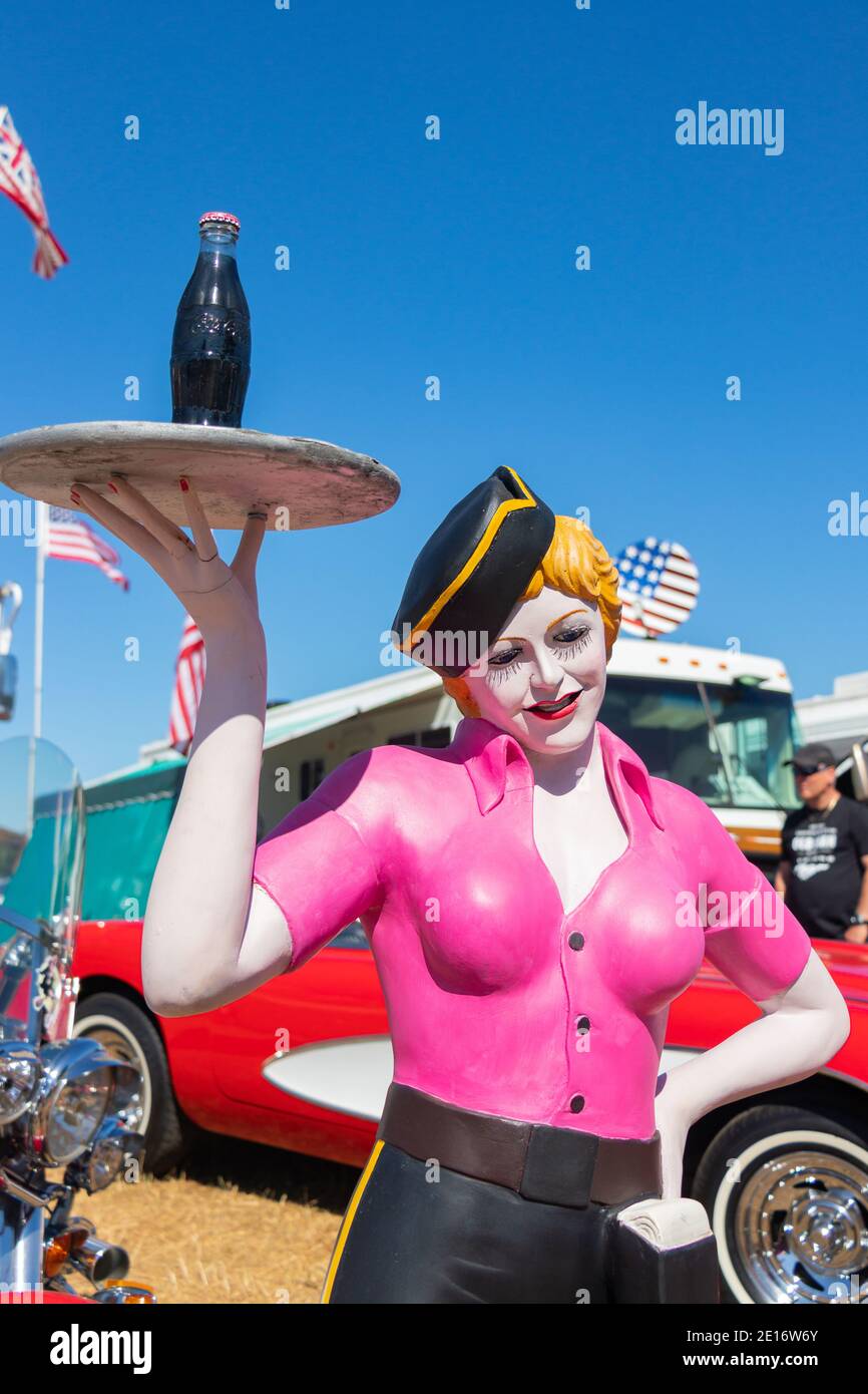 vintage mannequin of female fast food barhop server on roller skates at with coke on a tray at Stars & Stripes classic American car show Stock Photo