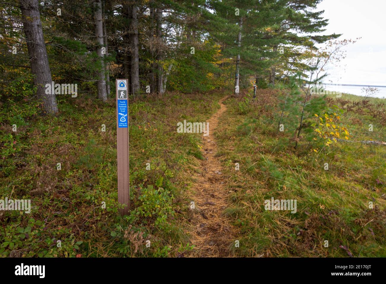 Bay Mills, Michigan, USA - October 3, 2020: Trail marker along the North Country National Scenic Trail along the coast of Lake Superior. Stock Photo