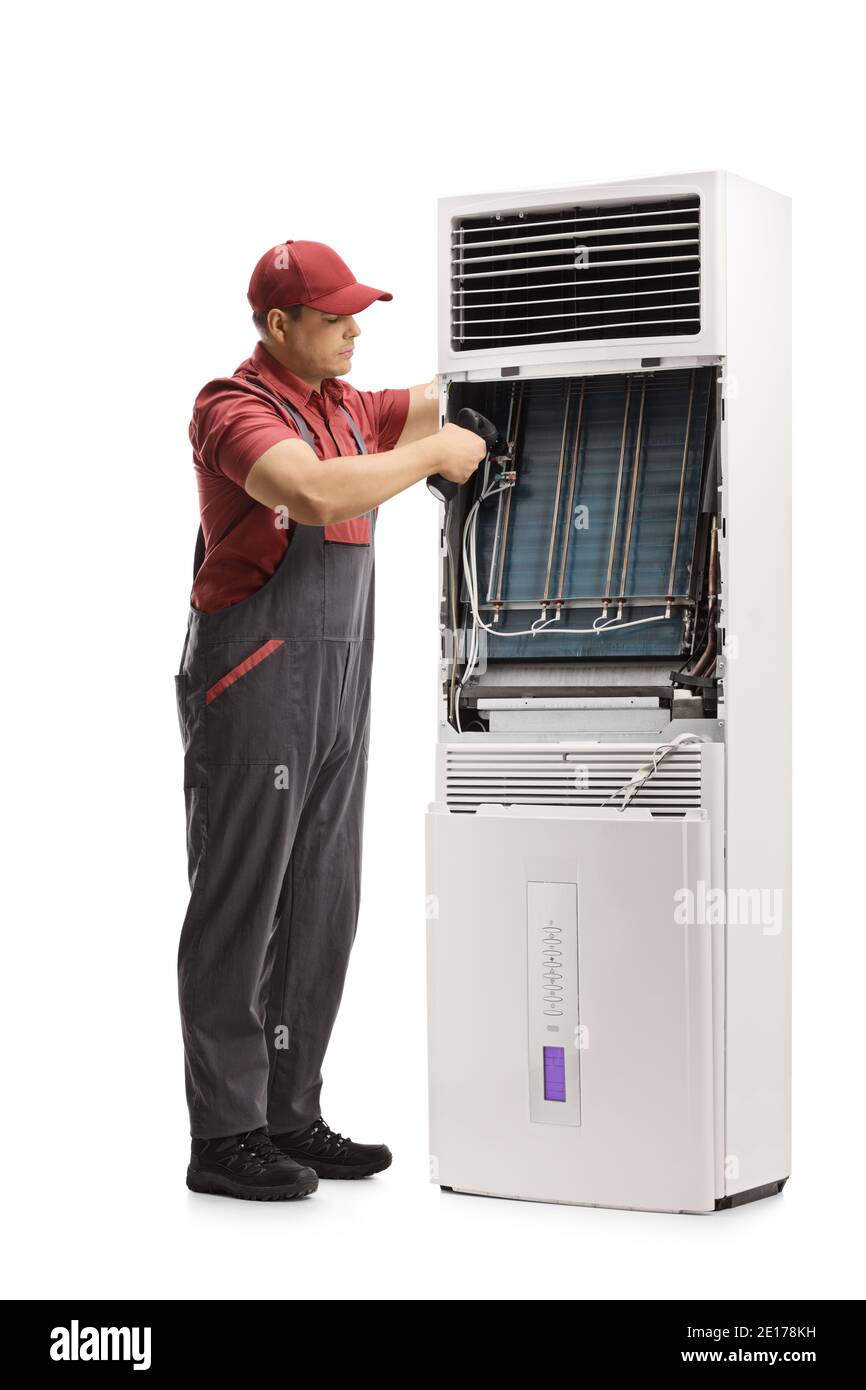Repairman fixing a self standing portable air conditioning unit isolated on white background Stock Photo