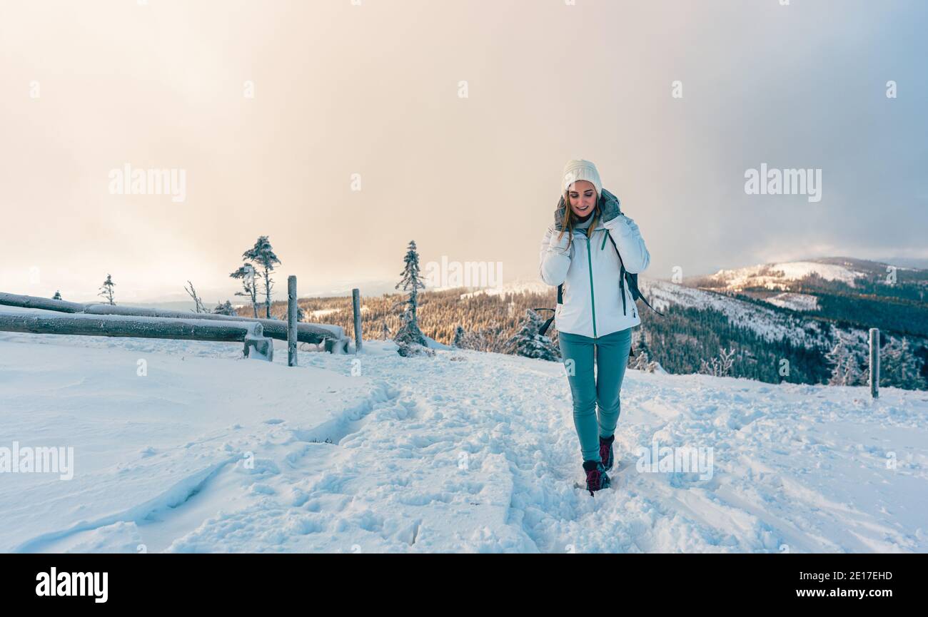 Woman hiking the Grosser Arber mountain in winter Stock Photo