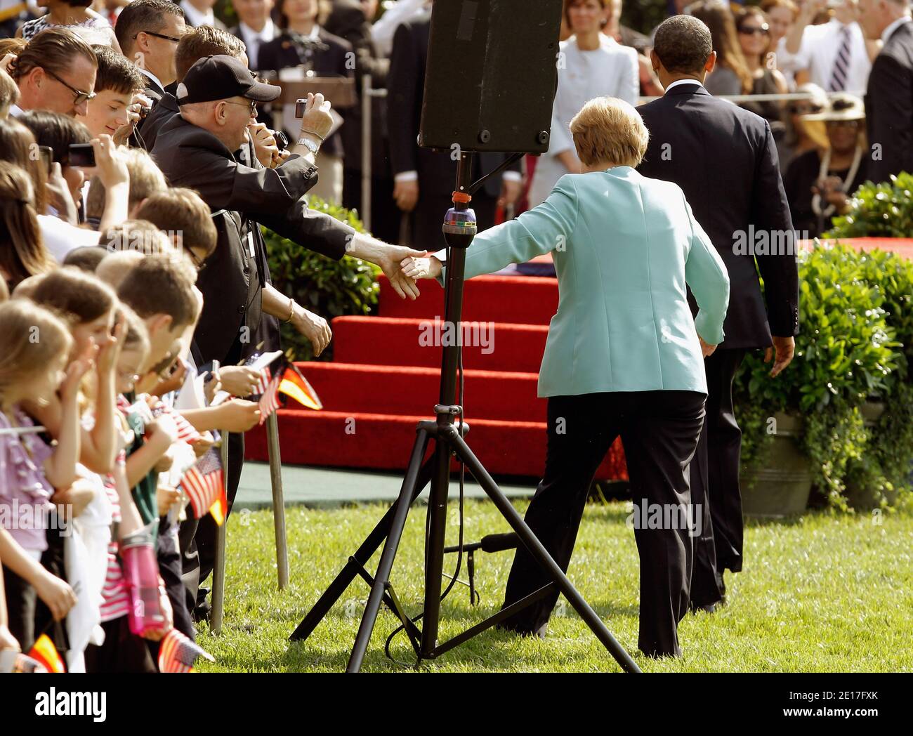 German Chancellor Angela Merkel (C) and U.S. President Barack Obama (R) greet guests on their way to the stage on the South Lawn of the White House during a ceremony in Washington, DC on June 7, 2011. This is the first official visit by a European leader to the White House since Obama became president. Merkel will be presented with the 2010 Medal of Freedom at a state dinner tonight. Photo by Chip Somodevilla/Pool/ABACAPRESS.COM Stock Photo