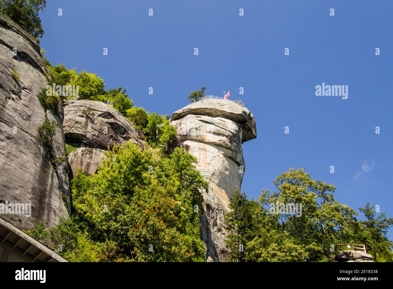 Chimney Rock at Chimney Rock State Park in North Carolina is a 315 foot monolith in the Blue Ridge Mountains. Stock Photo