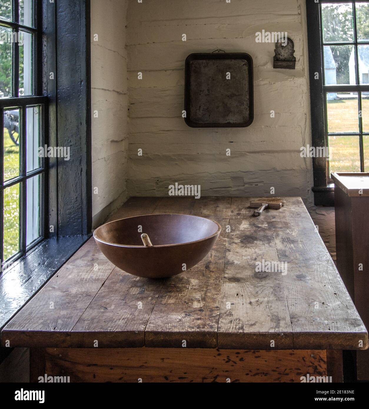 Simple rural farmhouse kitchen with wooden table and bowl in vertical orientation. Stock Photo