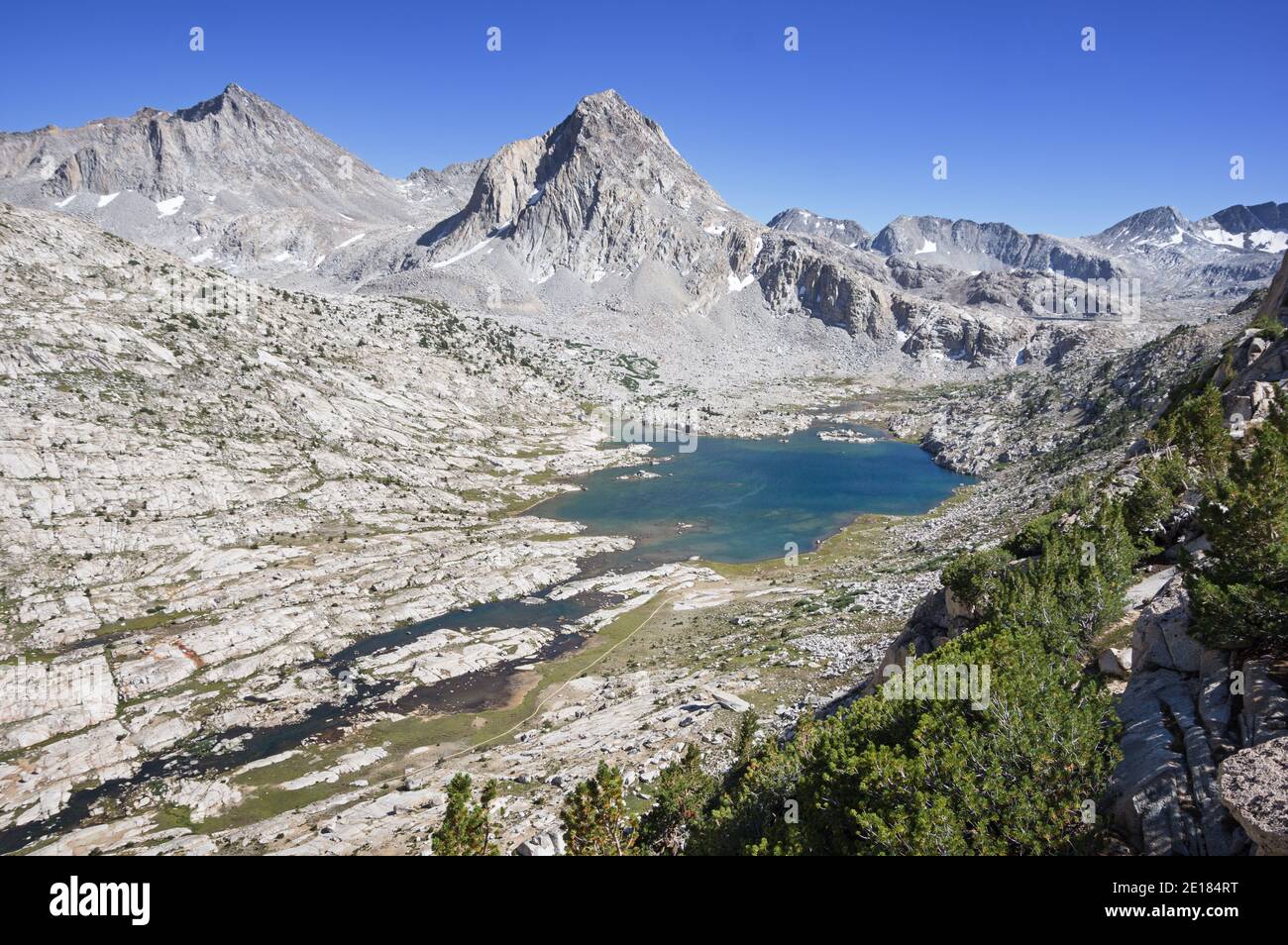 the JMT and PCT pass Saphire Lake in Evolution Basin with Mount Fiske and Mount Huxley Stock Photo