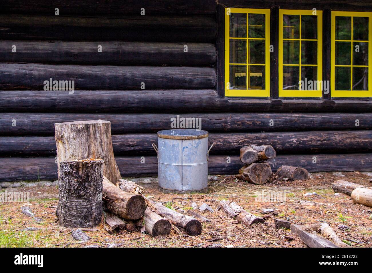Getting Ready For Winter. Chopping block for firewood outside a remote rustic Northwoods log cabin. This is a public property within a state park. Stock Photo