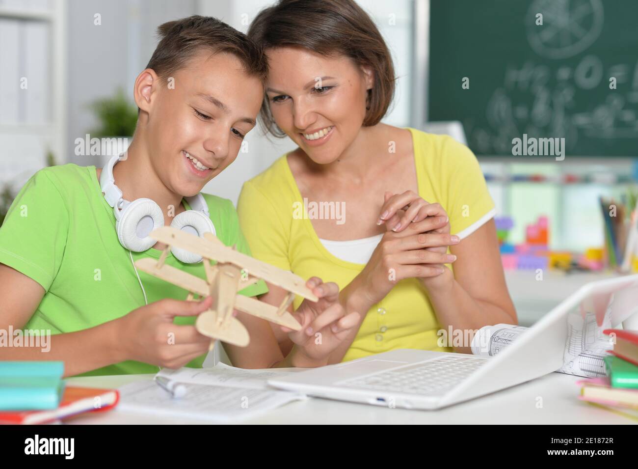 Young mother and cute son constructing with toy plane Stock Photo