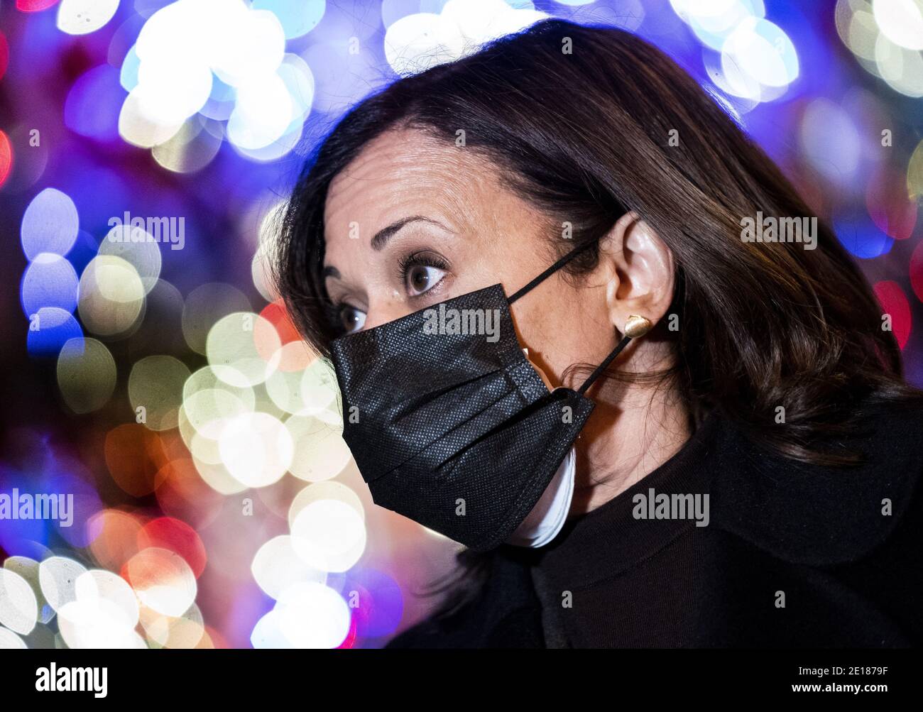 Washington, United States. 04th Jan, 2021. Vice President-elect Kamala Harris speaks to reporters as she her husband Doug Emhoff pick up a carry-out order from Floriana restaurant in Washington, DC on Monday, January 4, 2021. Pictured behind Harris is a Biden and Harris theme Christmas tree named, the 'Kamala LA LA LA Tree.' Photo by Kevin Dietsch/UPI. Credit: UPI/Alamy Live News Stock Photo
