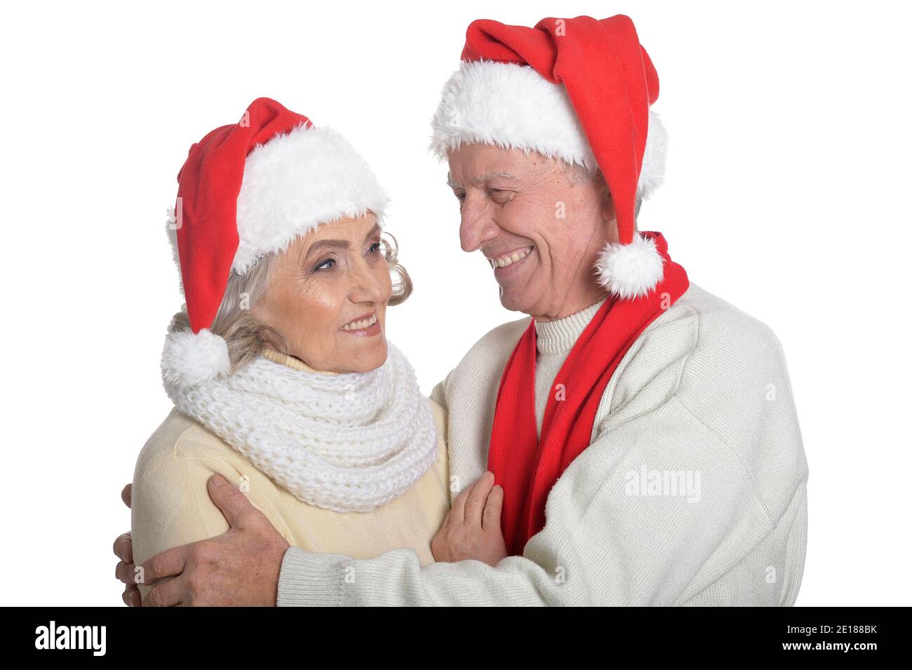 Portrait of happy senior couple in Santa hats Stock Photo