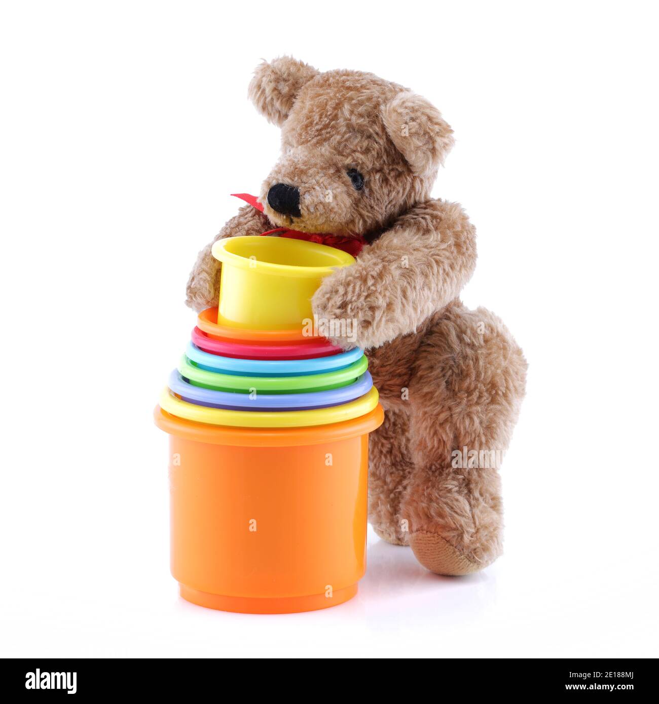 Brown teddy bear playing with toy pots containers Stock Photo