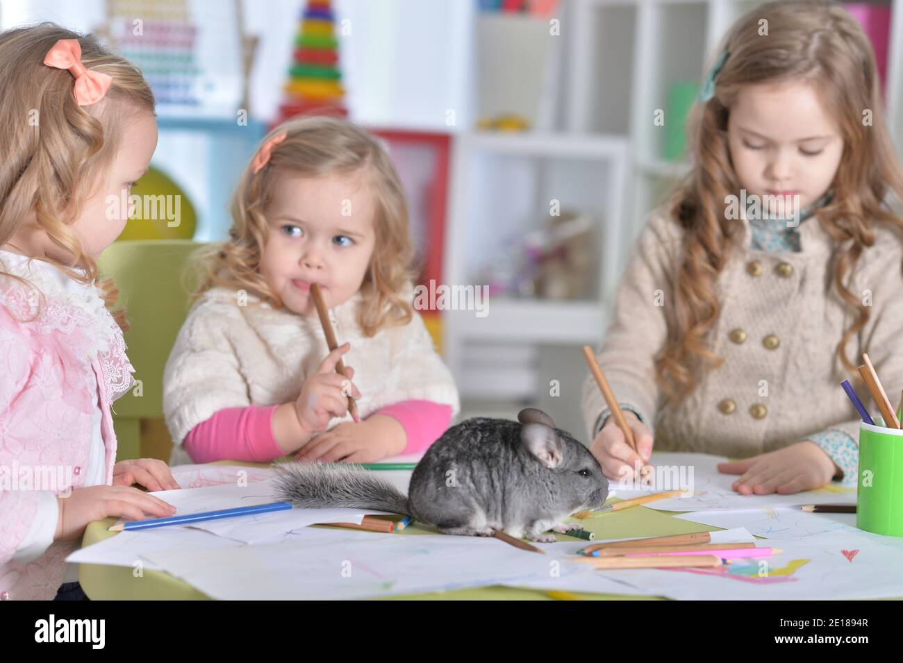 Portrait of little girls drawing with pencils Stock Photo - Alamy