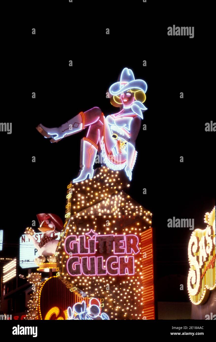 Colorful neon sign for Glitter Gulch casino depicts a cowgirl on