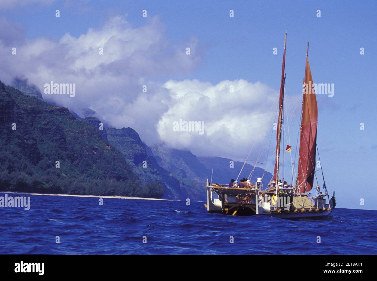 Hokulea, a traditional double hulled Hawaiian sailing canoe, sets sail off the Na Pali Coast for the voyage to the Northwestern Hawaiian Islands Stock Photo