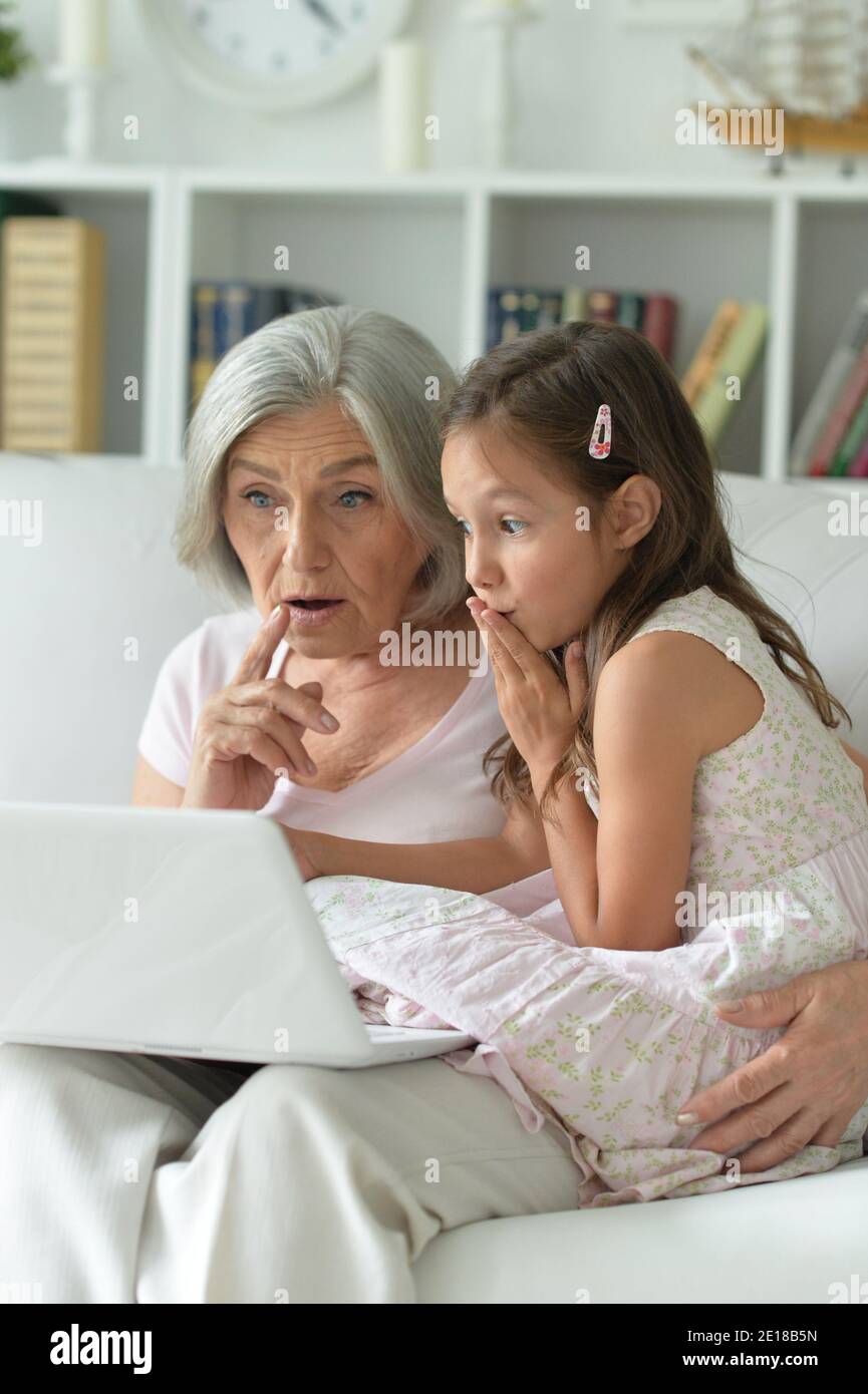 Portrait of grandmother and granddaughter using laptop Stock Photo - Alamy