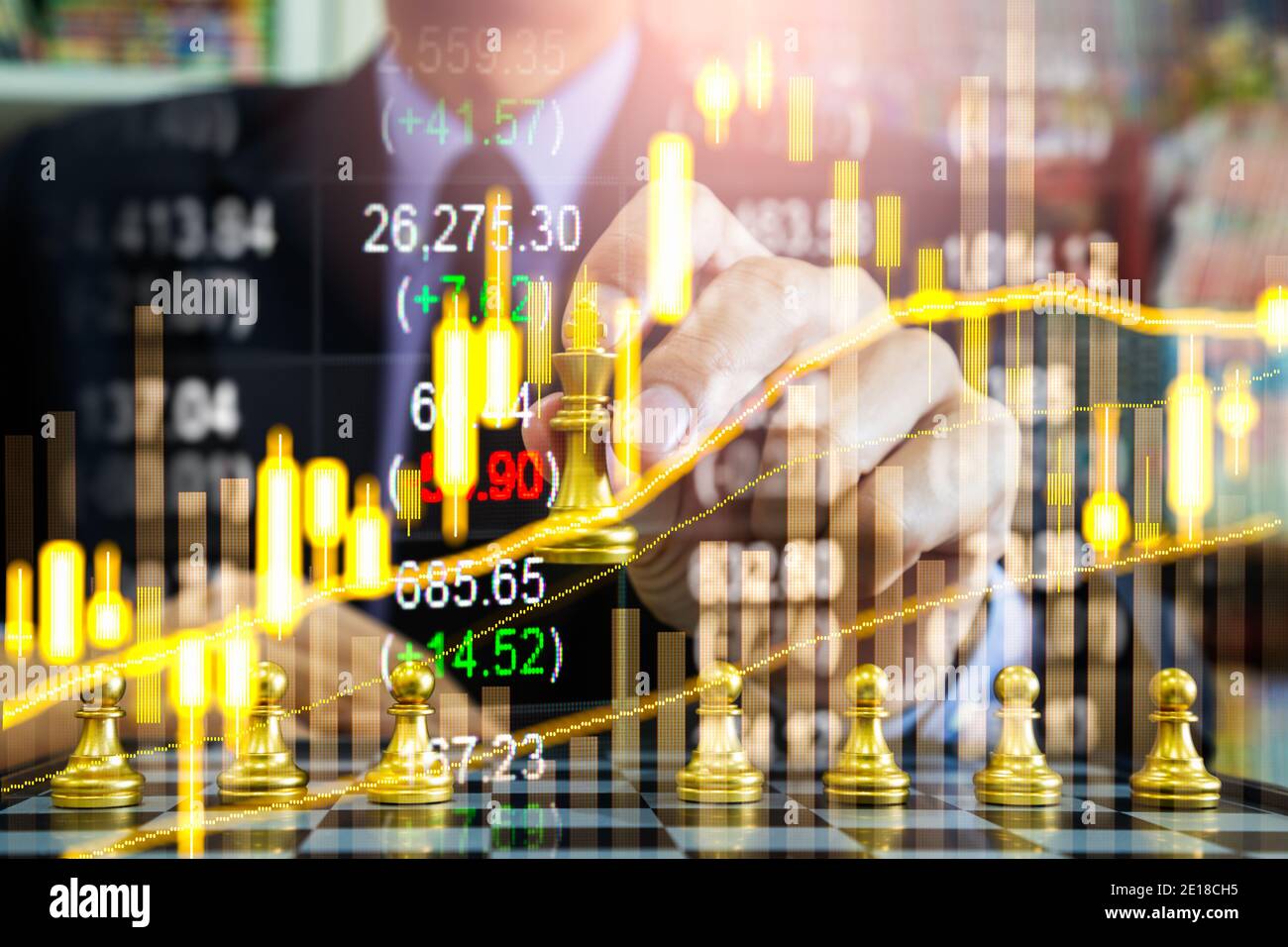 Chess game on chess board behind business man background. Business concept to present financial information and marketing strategy analysis. Investmen Stock Photo