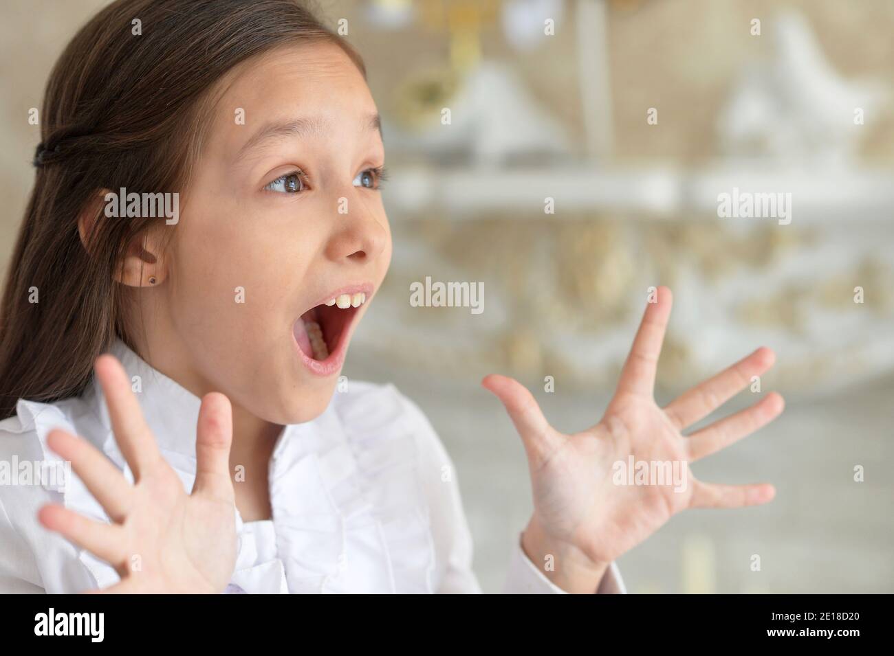 Close-up portrait of emotional little girl in white blouse Stock Photo ...
