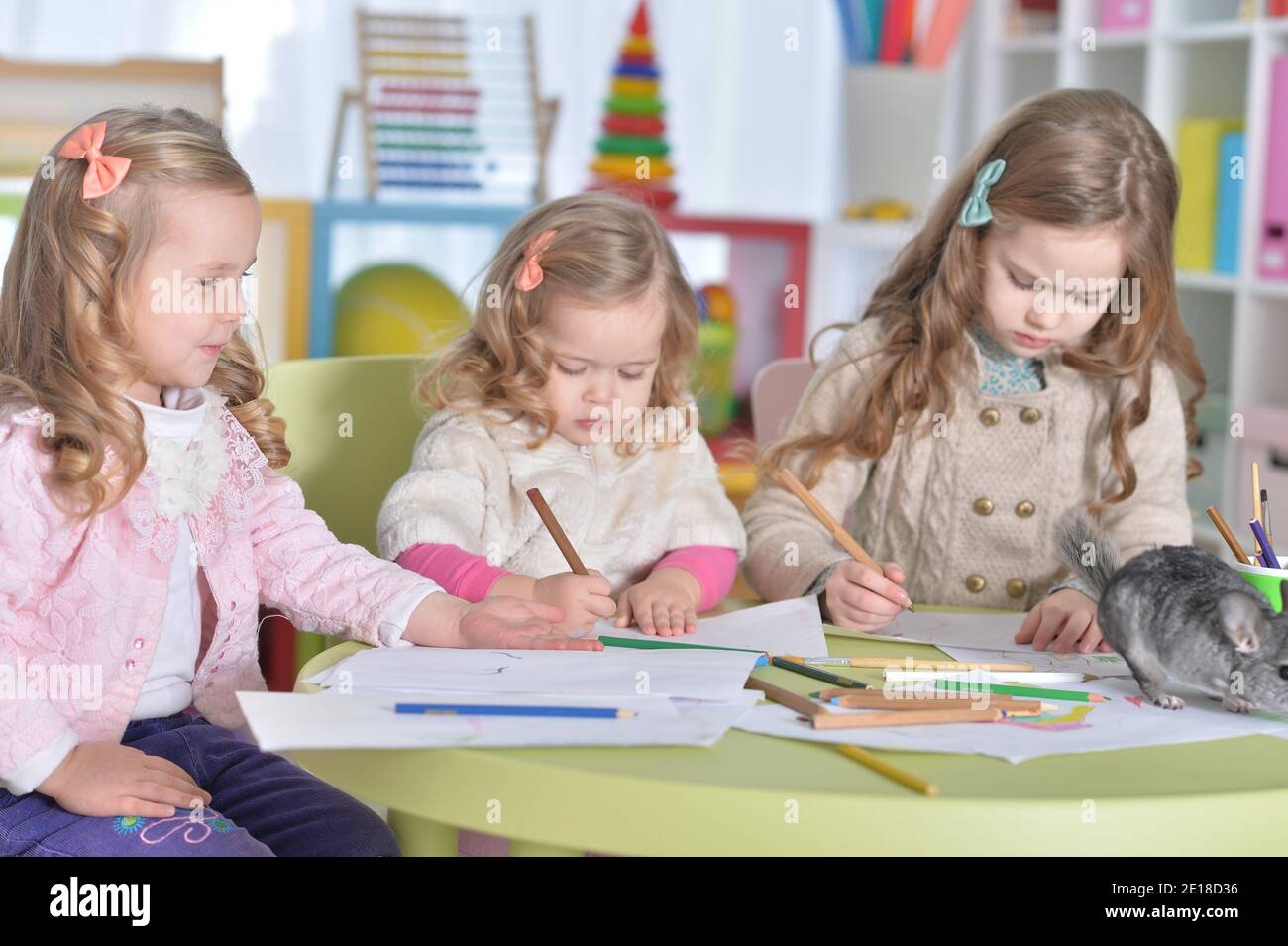 Portrait of little girls drawing with pencils Stock Photo - Alamy