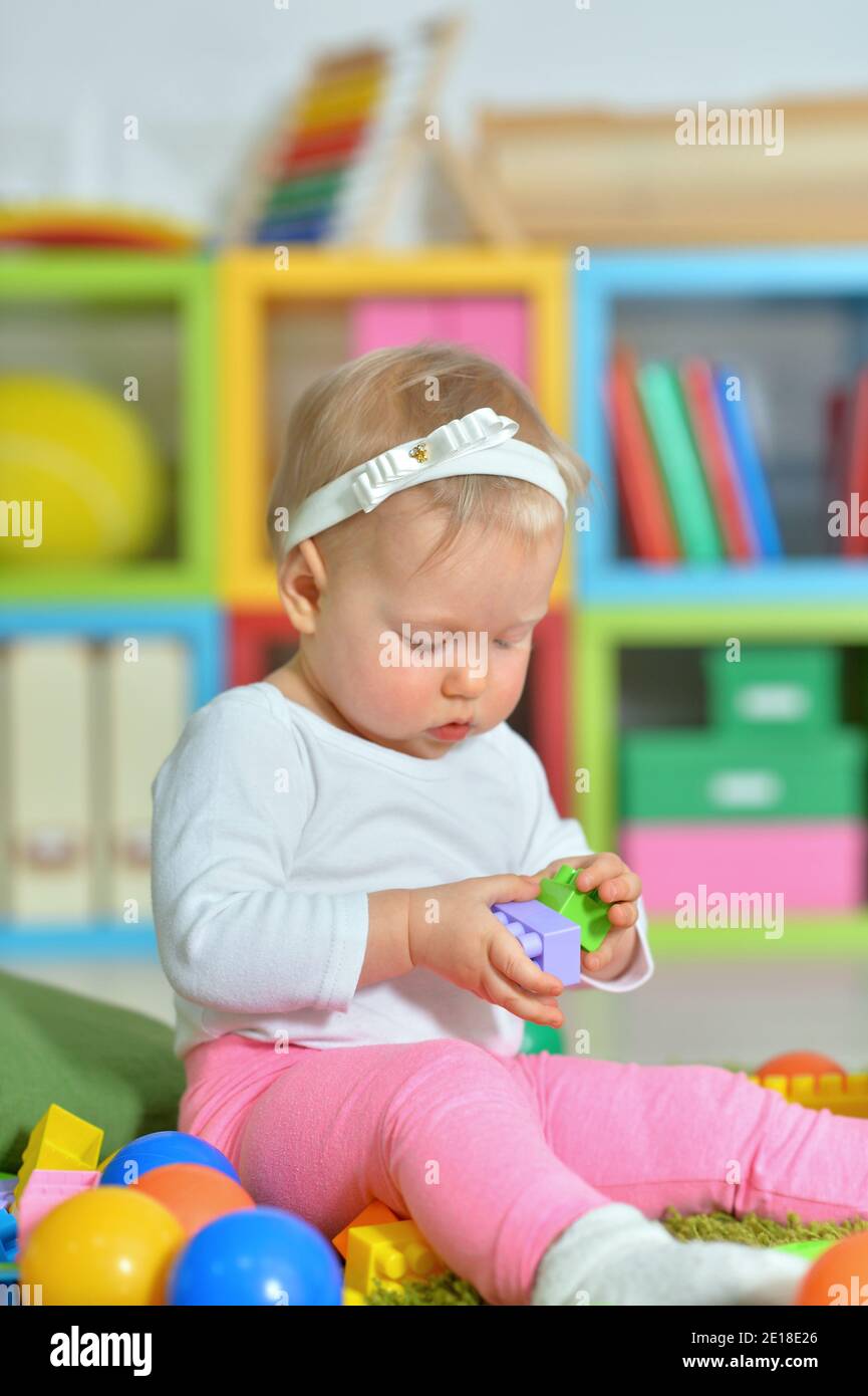 little child playing with colorful toys Stock Photo - Alamy