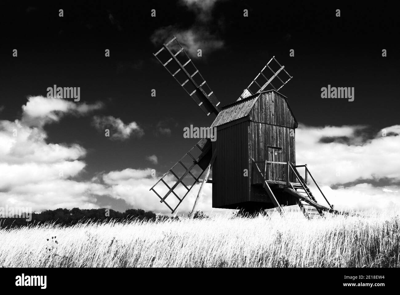 A black and white photo of a traditional Swedish wooden windmill located in province of Oland. Stock Photo