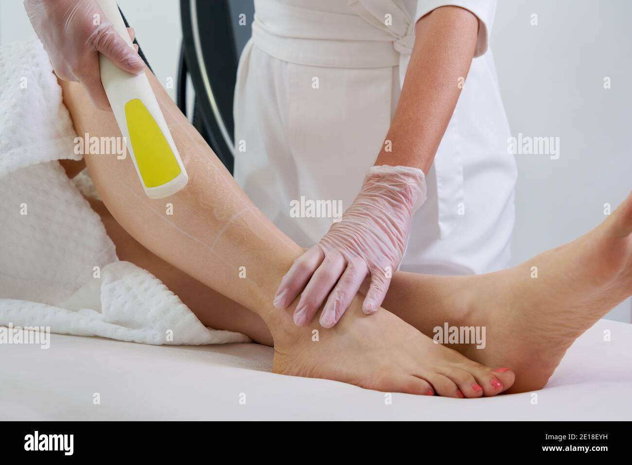 Woman in professional beauty clinic during laser hair removal Stock Photo