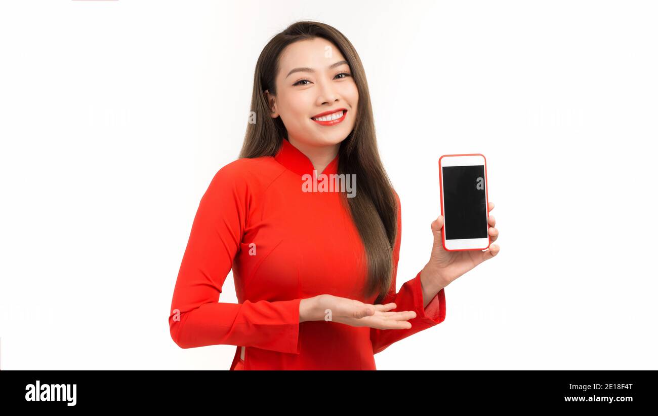 Young beautiful Asian woman pointing at black empty space on smart phone background can use for advertising or product presenting concept Stock Photo