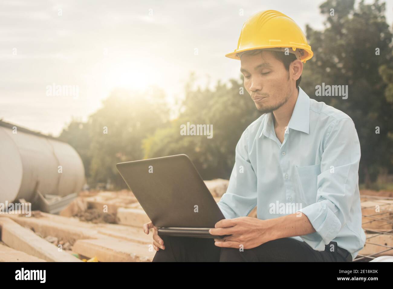 Engineering construction holding computer notebook inspection work at estate building project Stock Photo