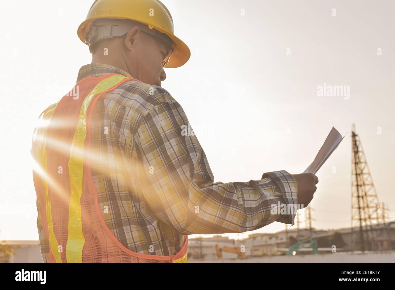 Engineer construction holding paper blueprint inspection building