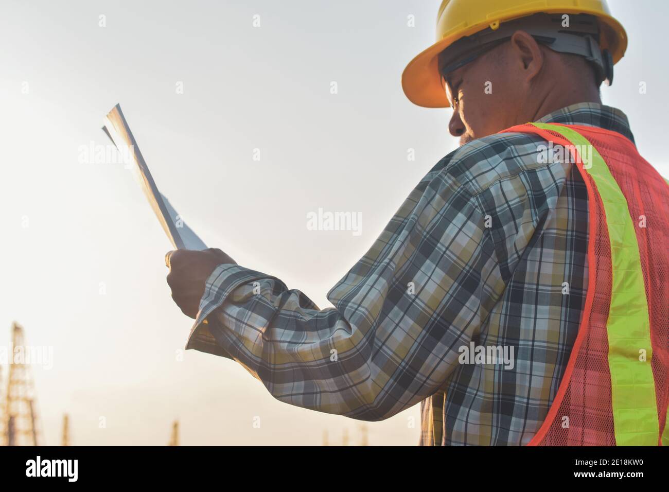 Engineer construction holding paper blueprint inspection building