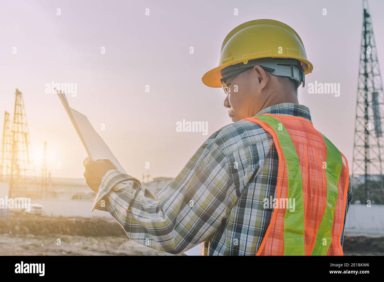 Engineer construction holding paper blueprint inspection building