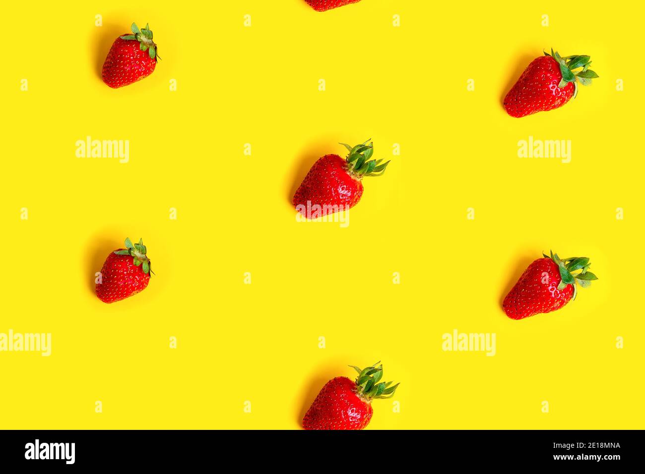 Abstract background with red fresh strawberryes on yellow background. Seamless pattern Stock Photo