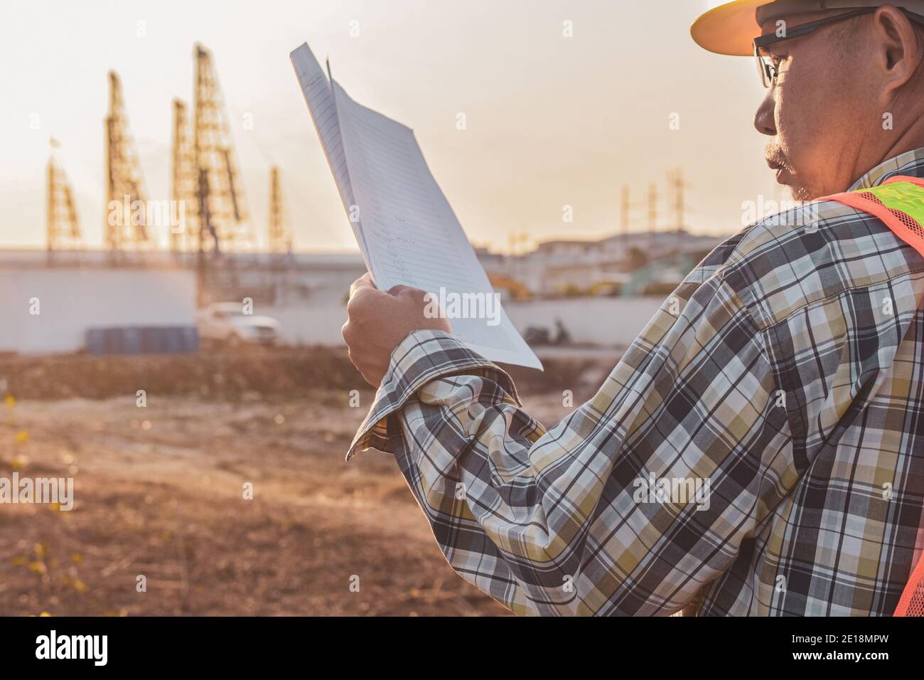 Senior Engineer Checking blueprint construction control management