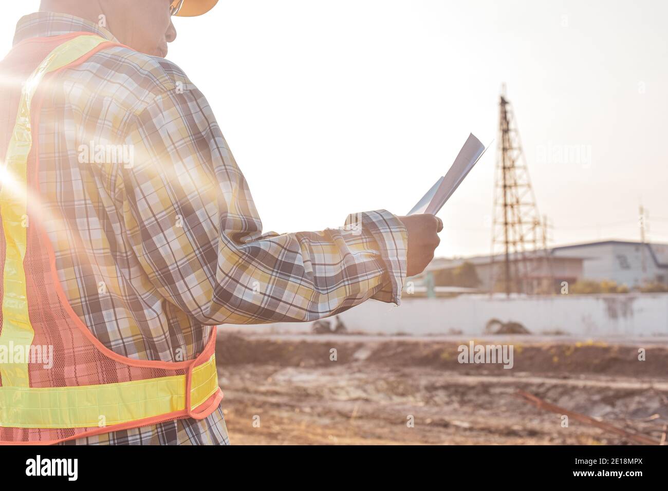 Senior Engineer Checking blueprint construction control management