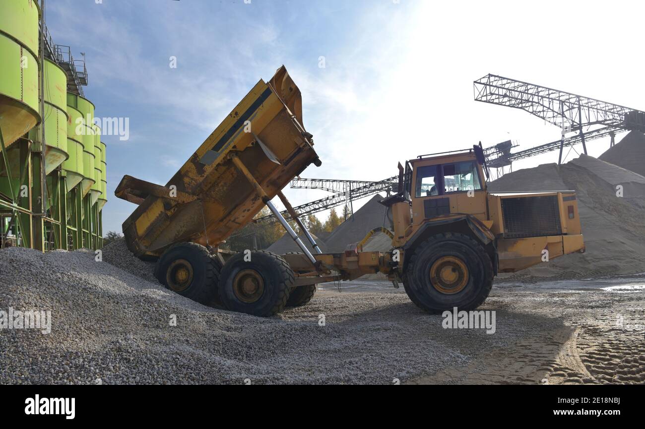 Gravel pit: building and wheel loader loading gravel onto a truck Stock Photo