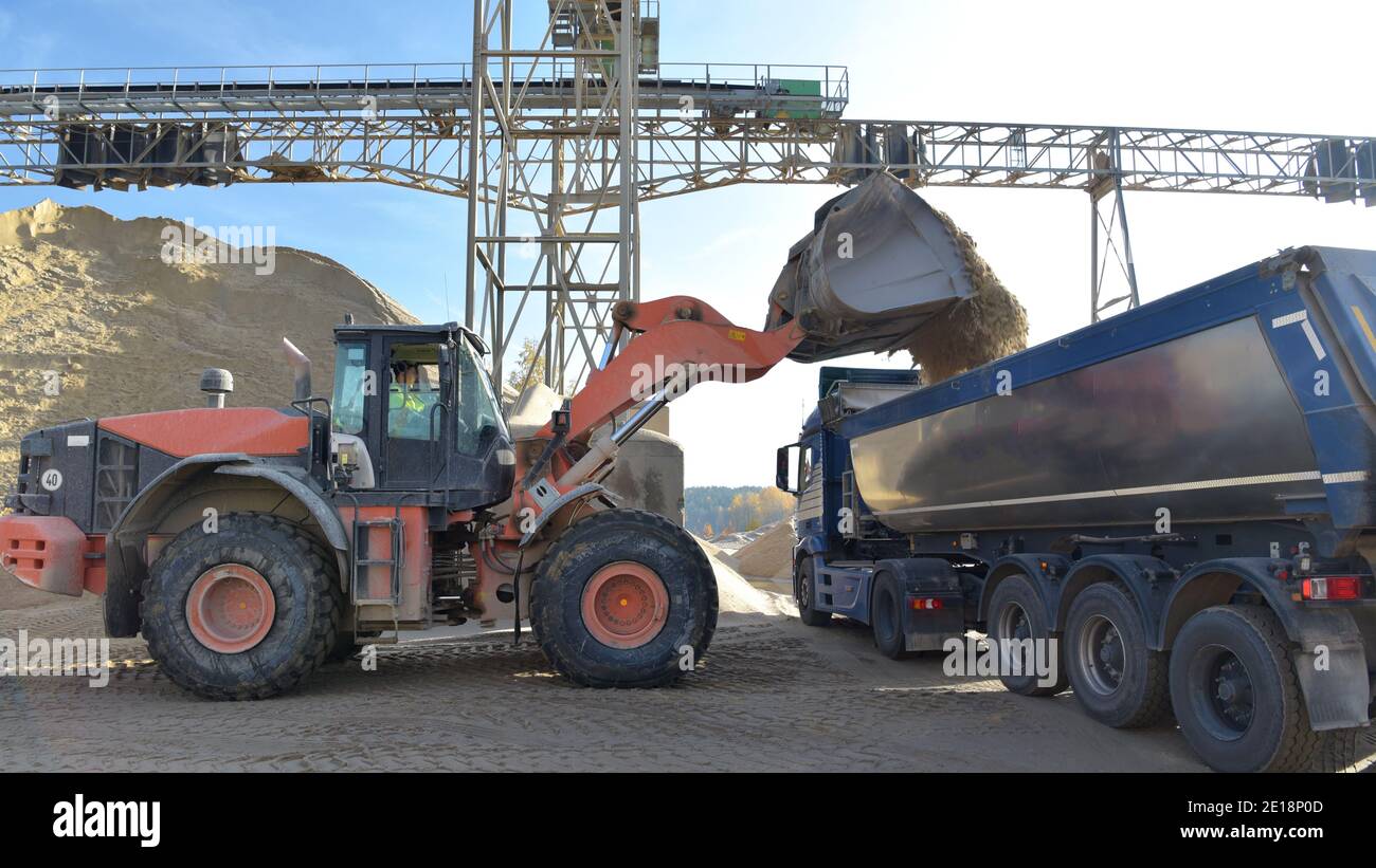 Gravel pit: building and wheel loader loading gravel onto a truck Stock Photo