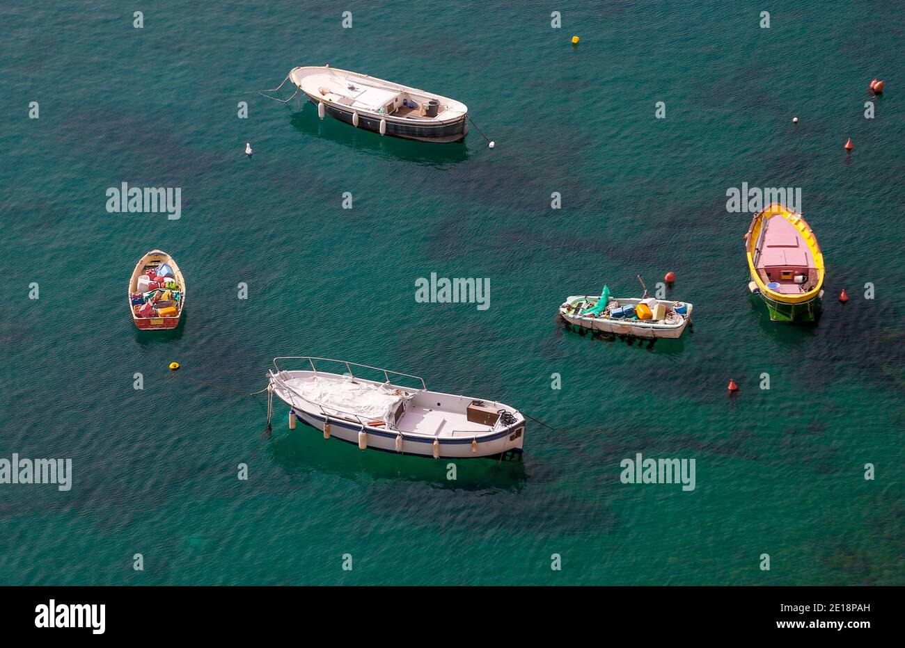 In the port of Corricella, island Procida, Italy, there are many different fishing boats. Stock Photo