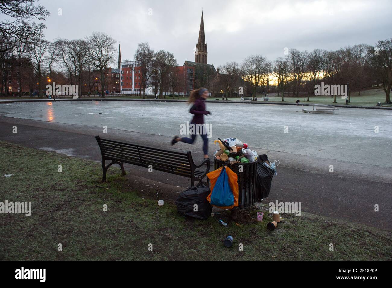 Glasgow, Scotland, UK. 5 January 2021. Pictured: A jogger taking in morning exercise. Queens Park in Shawlands, this morning showing only a few people around the park and on the ice, form a marked contrast to the scenes yesterday which saw hundreds of people on the ice, skating, playing hockey and around the park. As of 00:01 this morning Scotland has been placed into another lockdown as per the Scottish First Minister's address at 2pm yesterday. Credit: Colin Fisher/Alamy Live News. Stock Photo