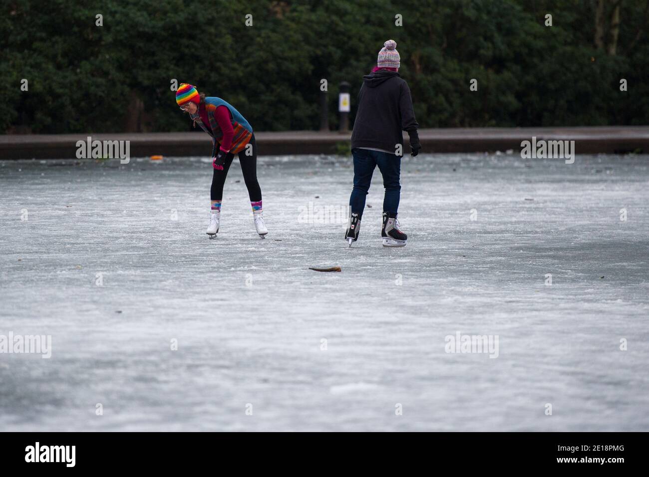 Glasgow, Scotland, UK. 5 January 2021. Pictured: Skaters on the pond ice. Queens Park in Shawlands, this morning showing only a few people around the park and on the ice, form a marked contrast to the scenes yesterday which saw hundreds of people on the ice, skating, playing hockey and around the park. As of 00:01 this morning Scotland has been placed into another lockdown as per the Scottish First Minister's address at 2pm yesterday. Credit: Colin Fisher/Alamy Live News. Stock Photo