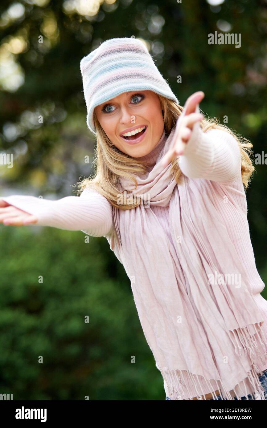 Beautiful woman greeting friends Stock Photo