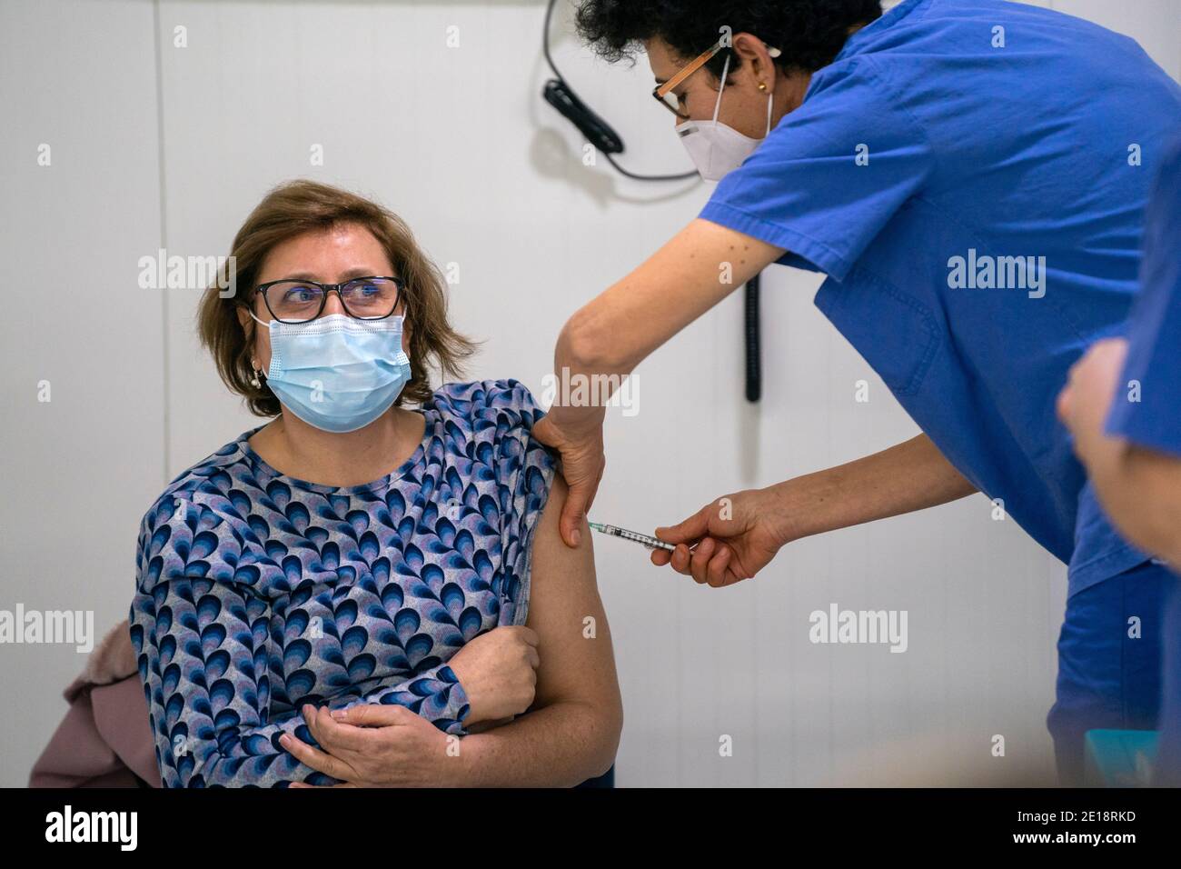 Nurse vaccinating a woman with the Covid 19 vaccine Stock Photo