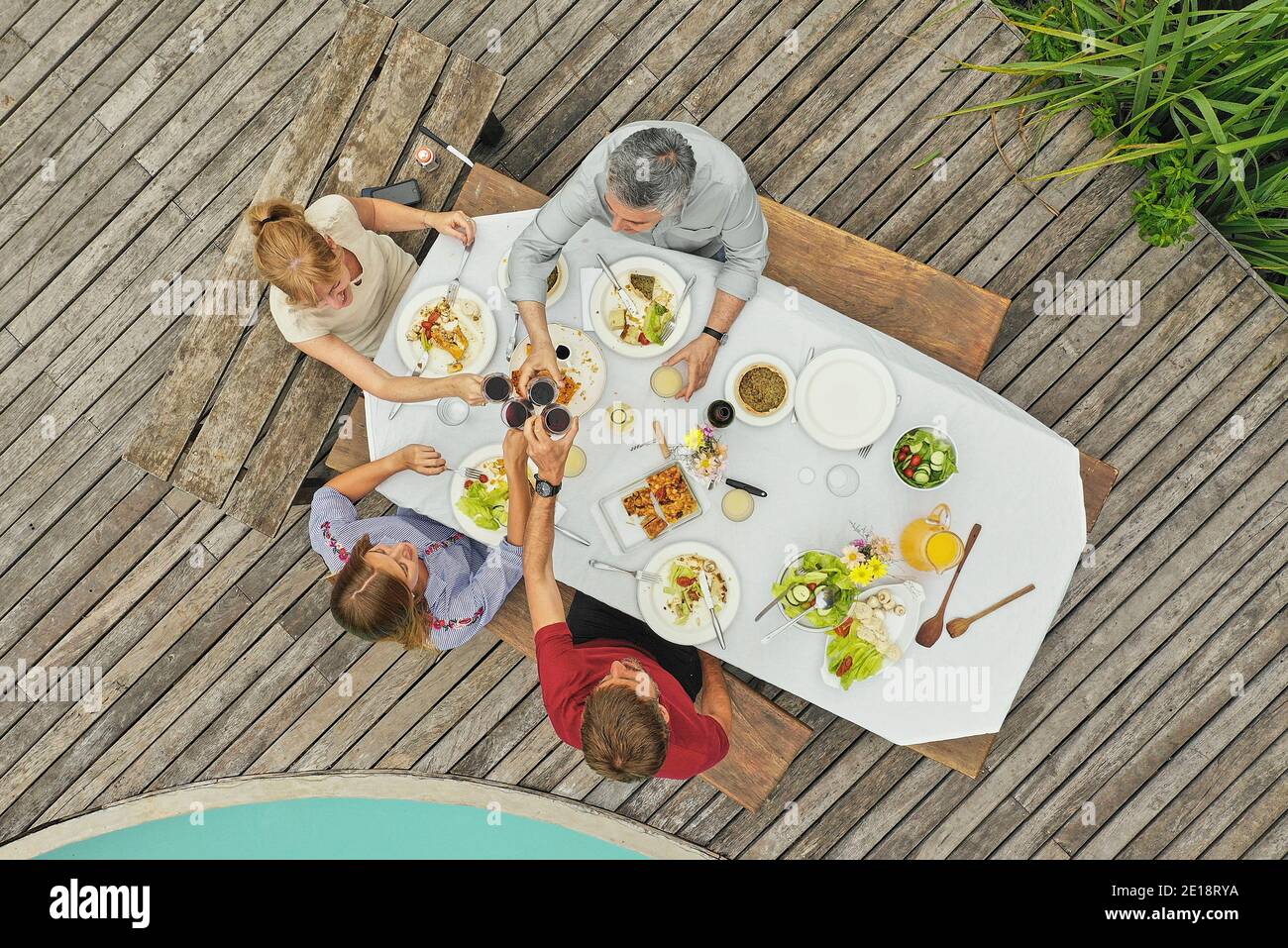 Family having lunch at poolside Stock Photo
