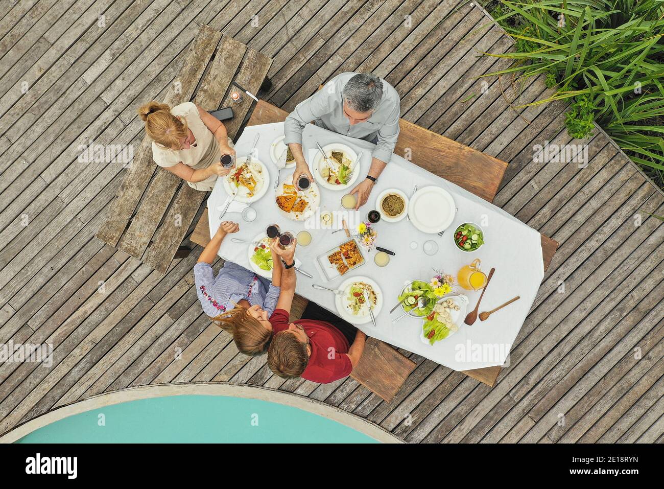 Family having lunch at poolside Stock Photo