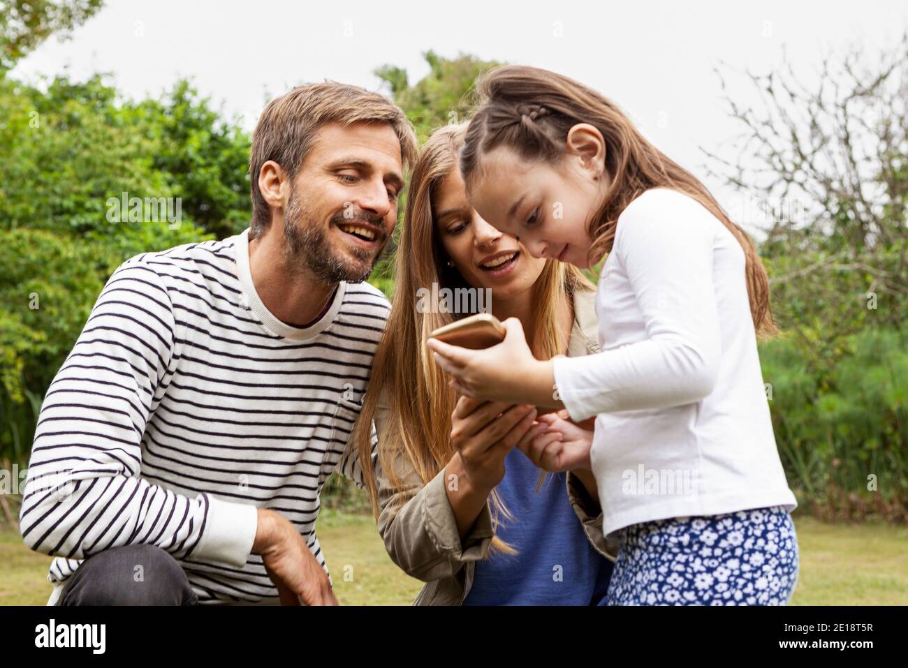 Happy family using smartphone Stock Photo